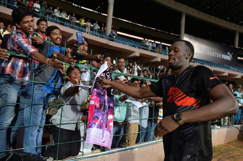 Usain Bolt greets fans in Bangalore during his cricket and sprint exhibition on Tuesday. Manjunath Kiran / AFP