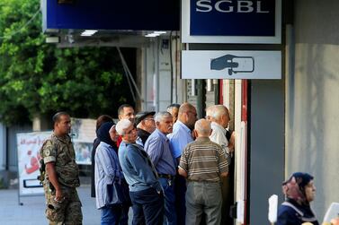 People queue outside a branch of SGBL bank in Sidon, as Lebanese banks reopened after two weeks on November 1, 2019.Reuters