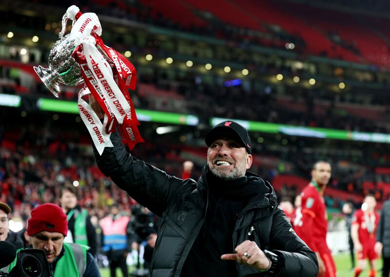 Liverpool manager Jurgen Klopp celebrates with the trophy after winning the League Cup on February 27, 2022. Reuters