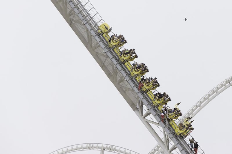 Staff evacuate passengers on the Flying Aces rollercoaster at Ferrari World Abu Dhabi on Friday. Christopher Pike / The National