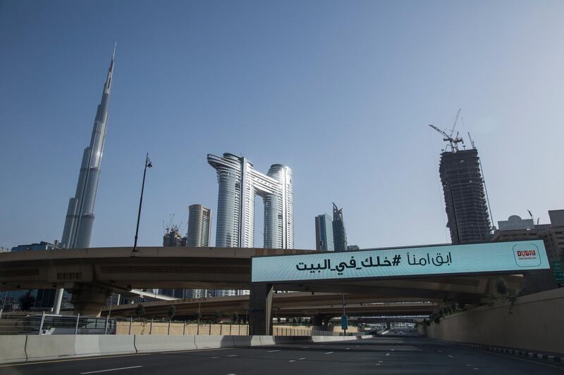 A sign reading in Arabic 'stay at home' is seen on the almost empty streets of Dubai.  EPA