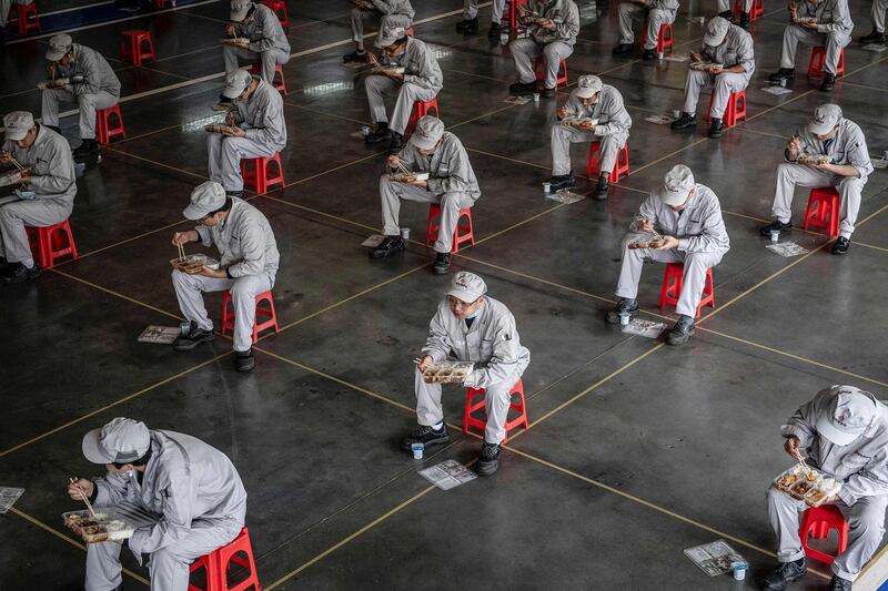 Employees eating during lunch break at an auto plant of Dongfeng Honda in Wuhan in China's central Hubei province.  AFP