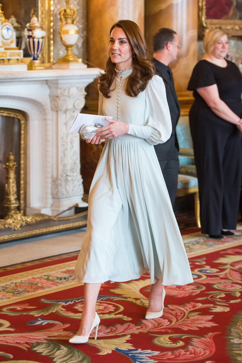 The Duchess of Cambridge wears a light blue dress, designed for the royal by a private dressmaker, according to Kensington Palace, for a reception marking the 50th anniversary of the investiture of the Prince of Wales at Buckingham Palace on March 5. The bespoke dress was worn with off-white Emmy London heels and an Alexander McQueen clutch. Getty Images