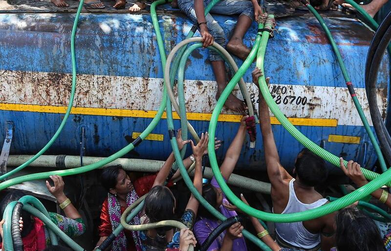 People collect water from a water tanker, in Bhiwandi, some 60 kilometres on the outskirts of Mumbai, India. According to reports, 21 districts in Maharashtra are drought-affected. The drought, which has been ongoing for the past five months, prompted 11 states to declare a drought in 2015 and has now choked the growth of kharif (monsoon) crops, including sesame, millet and rice, for the second monsoon season in a row. Divyakant Solanki / EPA