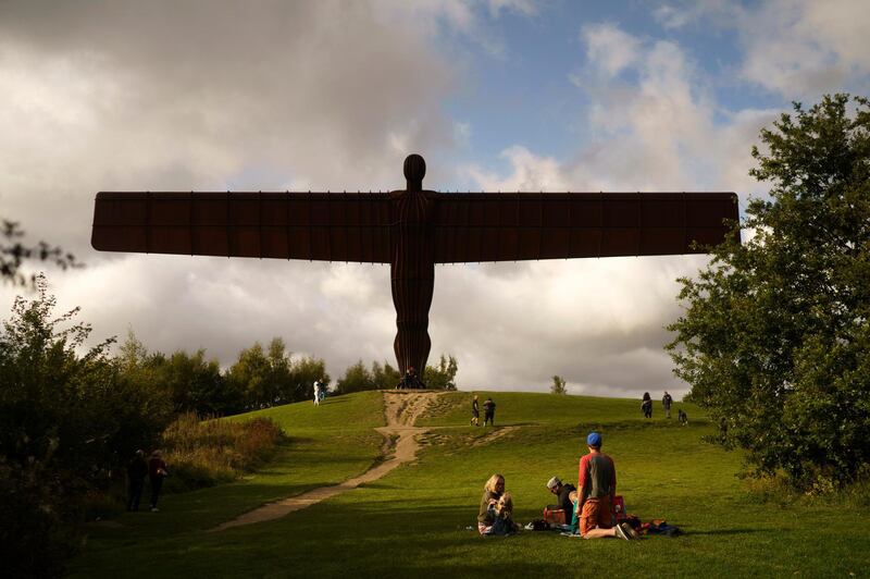 A family enjoy a picnic next to the Angel of the North in Gateshead. Getty Images