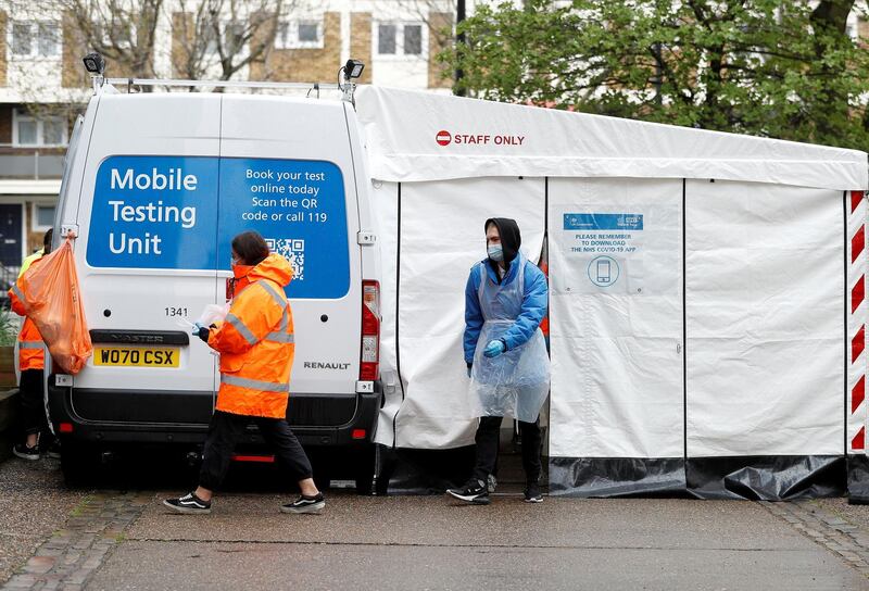 NHS workers are seen next to a coronavirus disease (COVID-19) mobile testing unit in Tower Hamlets, London, Britain, May 2, 2021. REUTERS/Peter Nicholls