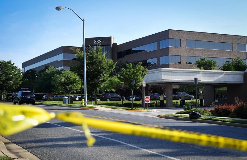 Police tape blocks access from a street leading to the building complex where The Capital Gazette is located on June 29, 2018, in Annapolis, Maryland. - Jarrod Ramos, suspected of carrying out a deadly assault on the newspaper office, had barricaded a back door in an effort to "kill as many people as he could kill," police said. (Photo by Mandel Ngan / AFP)