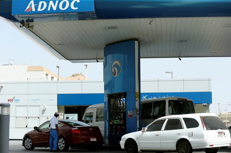 A worker injects a car with fuel at an ADNOC petrol station in Abu Dhabi, United Arab Emirates July 10, 2017. REUTERS/Stringer - RC1BD3E15A80