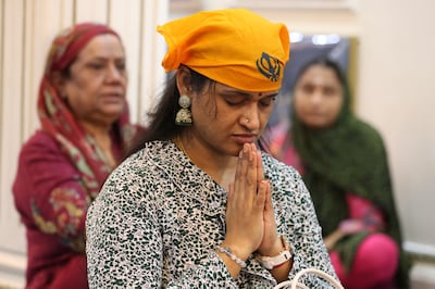 A Sikh devotee praying at the gurudwara inside the temple complex in Bur Dubai. Chris Whiteoak / The National
