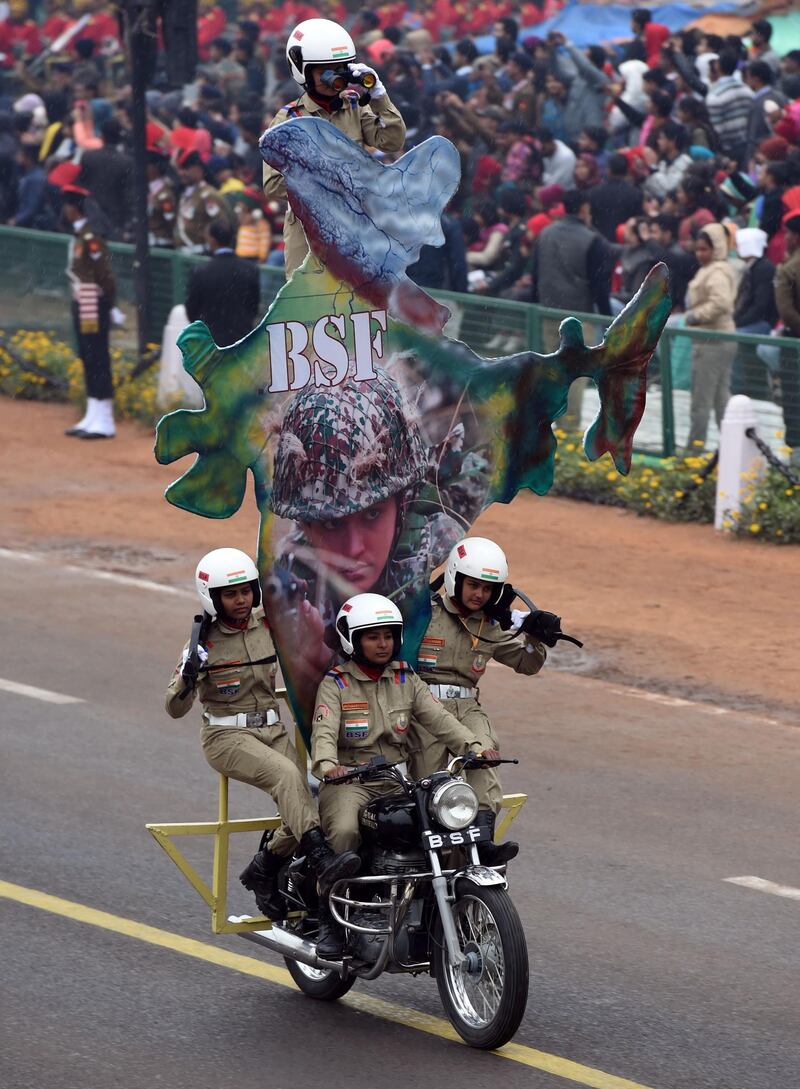Indian Border Security Force (BSF) biker squad members whiz by on a motorcycle. Money Sharma  / AFP Photo