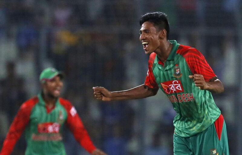 Bangladesh’s Mustafizur Rahman, right, was fined half his match fees after colliding with MS Dhoni, the India captain. AM Ahad / AP Photo