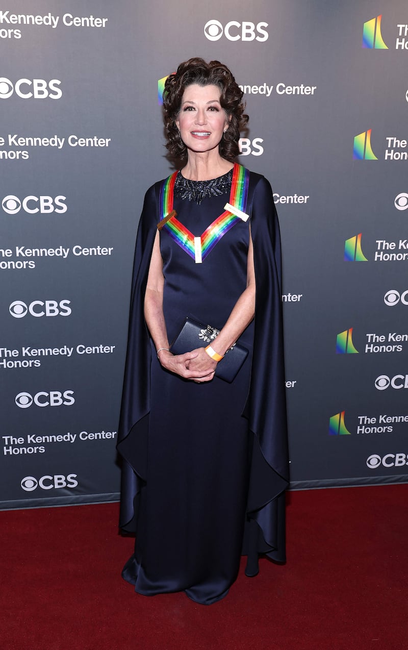 Honouree Amy Grant wearing a navy caped gown. Getty Images 