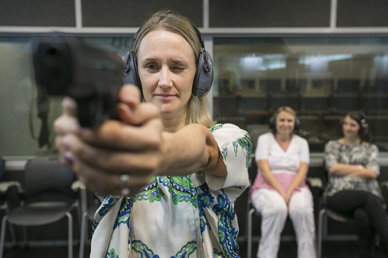 Kay Jones-Swift aims at the target on a ladies' shooting night. Mona Al-Marzooqi / The National 

