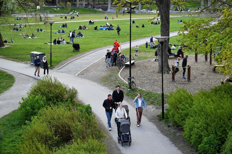 People enjoy a spring day at the Ralambshov park during the coronavirus disease (COVID-19) outbreak in Stockholm, Sweden May 8, 2020. Henrik Montgomery /TT News Agency/via REUTERS ATTENTION EDITORS - THIS IMAGE WAS PROVIDED BY A THIRD PARTY. SWEDEN OUT. NO COMMERCIAL OR EDITORIAL SALES IN SWEDEN.