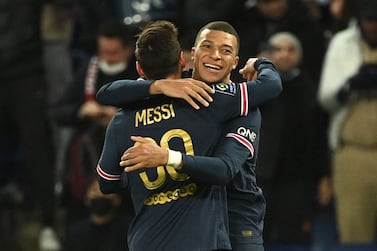 Paris Saint-Germain's French forward Kylian Mbappe celebrates with Paris Saint-Germain's Argentinian forward Lionel Messi after scoring a goal during the French L1 football match between Paris Saint-Germain (PSG) and AS Monaco (ASM) at the Parc des Princes stadium in Paris, on December 12, 2021.  (Photo by Anne-Christine POUJOULAT  /  AFP)