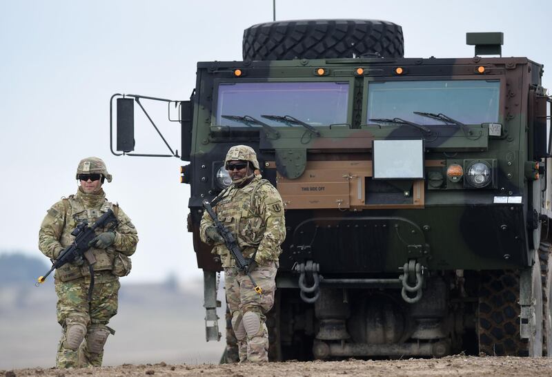 (FILES) In this file photo taken on March 04, 2020, US soldiers patrol prior to an artillery live fire event by the US Army Europe's 41st Field Artillery Brigade at the military training area in Grafenwoehr, Germany.  Germany on June 7, 2020, voiced concern at reports that US President Donald Trump plans to cut the number of US troops stationed in Germany, amid fears it could weaken a key pillar of NATO defence in the region. / AFP / Christof STACHE
