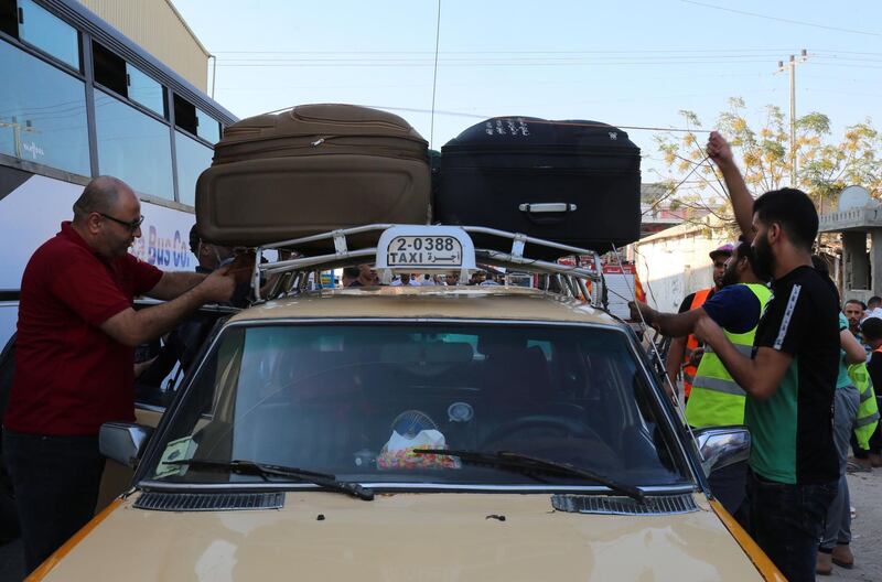 Palestinians load bags atop a taxi before travelling to Egypt through the Rafah border crossing in the southern Gaza Strip, on September 26, 2018. Since mid-May, after five long years in which the frontier was largely closed, Egyptian authorities have opened the crossing several days a week.
About 200 people make the trip in a day, a small number compared to the nearly two million people crammed into Gaza.
Yet it represents one of only two routes out of the strip and the only one not controlled by Israel.
 / AFP / SAID KHATIB

