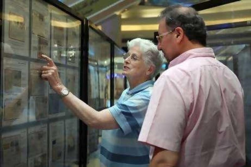 United Arab Emirates - Sharjah - September 22, 2010.

NATIONAL: Jenny Banfield (cq-al), of New Zealand, shows off her prized collection to fellow stamp enthusiast Freddy Khalastchy (cq-al), of London, at the 2010 Sharjah Arabian Stamp Exhibition in the Mega Mall in Sharjah on Wednesday, September 22, 2010. Amy Leang/The National