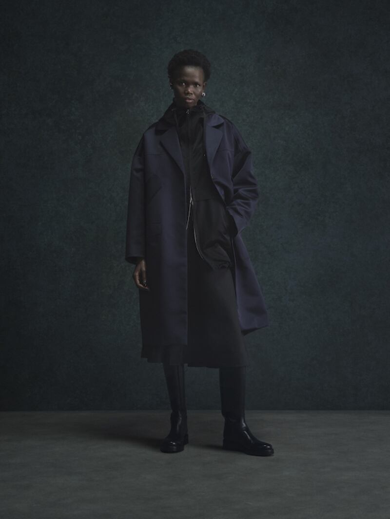 Stove pipe trousers and a midnight blue outer coat.