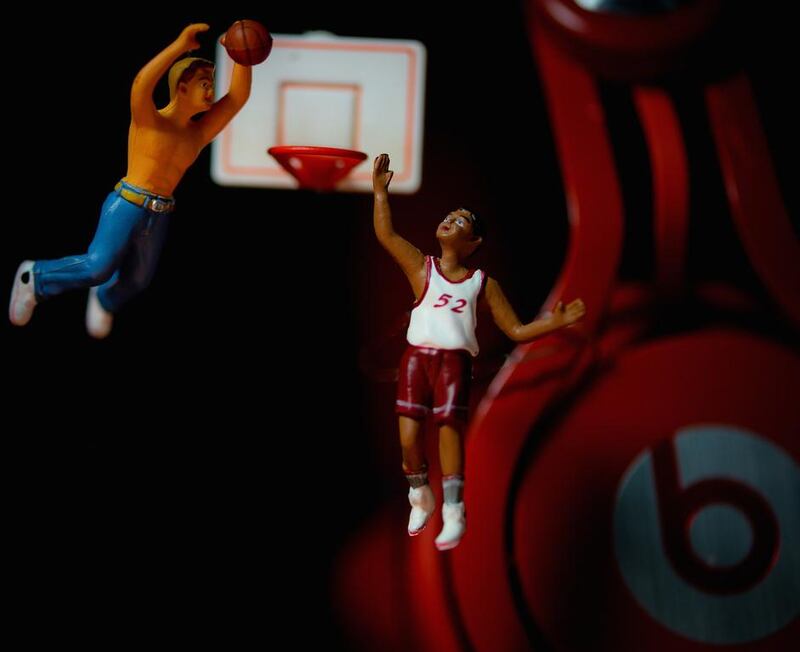 Men play basketball on a tiny court near Beats by Dre headphones. Courtesy Omar Maree Humaid