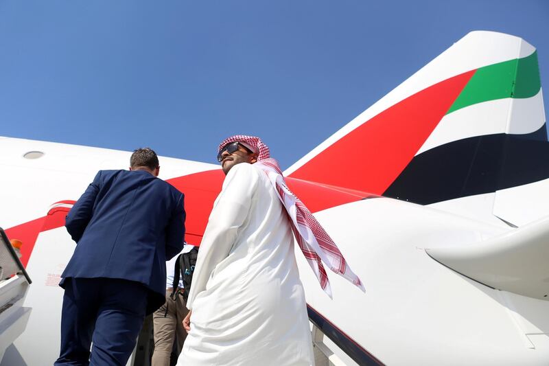 Attendees board an Airbus SE A380-800 passenger aircraft, operated by Emirates Airlines, during the 15th Dubai Air Show at Dubai World Central (DWC) in Dubai, United Arab Emirates, on Monday, Nov. 13, 2017. The biennial Dubai expo is an important venue for manufacturers to secure deals for their biggest and most expensive jetliners. Photographer: Natalie Naccache/Bloomberg