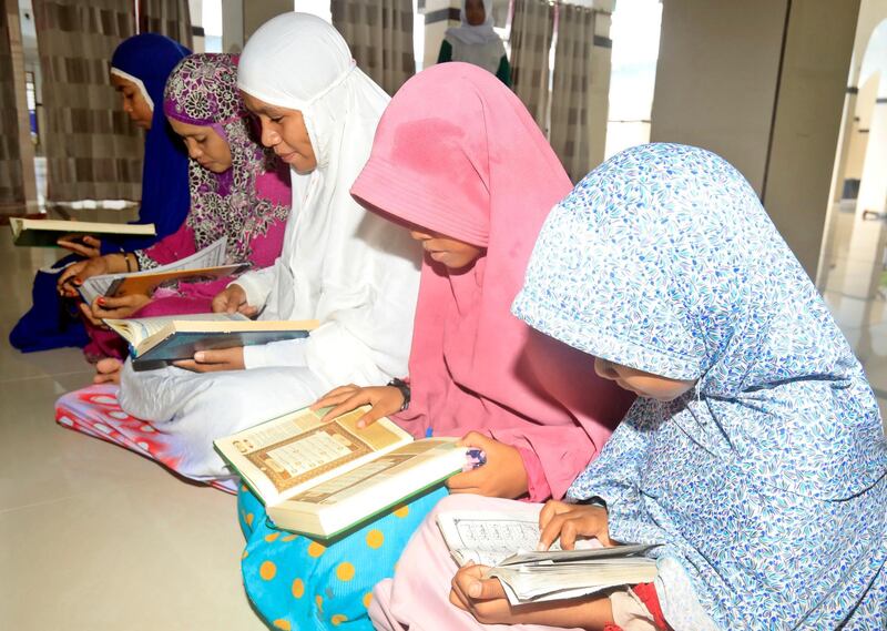 Muslim women read the Quran inside the Annur Mosque in Dili, East Timor.  EPA