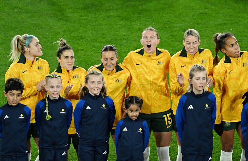 Australia's players line up for the anthems before the match. REUTERS