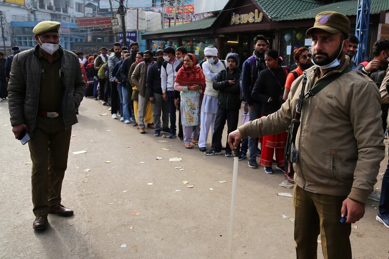 Devotees line up for registration to visit the shrine after the stampede. AP Photo