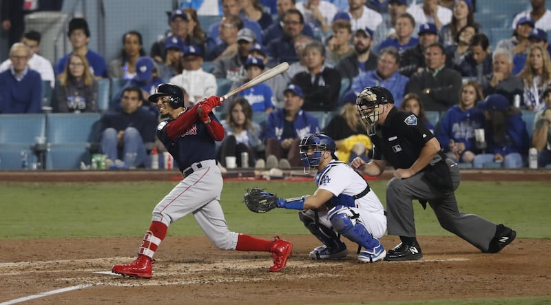Boston Red Sox batter Mookie Betts hits a solo home run. EPA