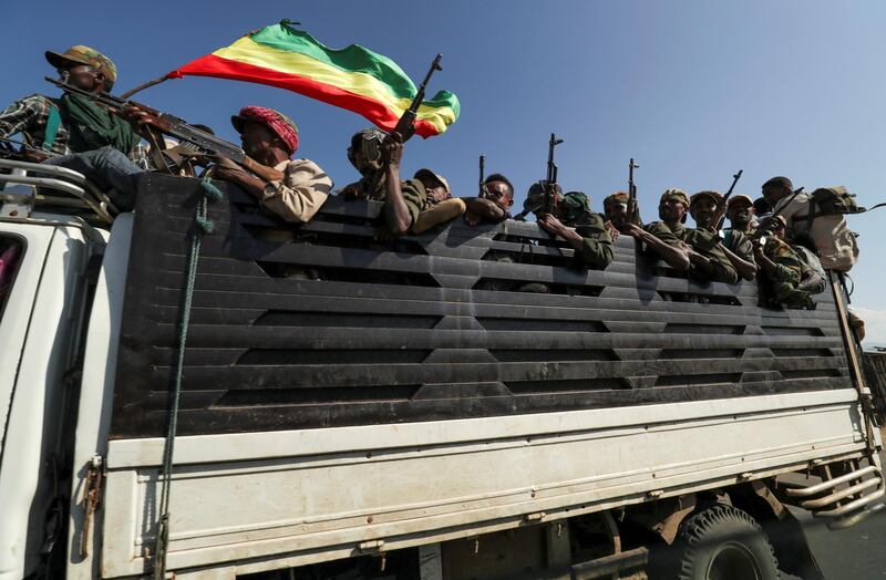 FILE PHOTO: Amhara region militiamen ride on their truck as they head to face the Tigray People's Liberation Front (TPLF), in Sanja, Amhara region near the border with Tigray, Ethiopia November 9, 2020. To match Special Report ETHIOPIA-CONFLICT/TIGRAYANS   REUTERS/Tiksa Negeri/File Photo