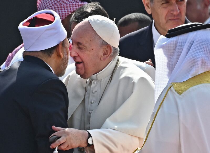 Pope Francis (C) embraces Bahrain's Grand Imam of al-Azhar mosque Sheikh Ahmed Al-Tayeb as King Hamad bin Isa al-Khalifa (R) looks on during a ceremony at Sakhir Royal Palace. AFP