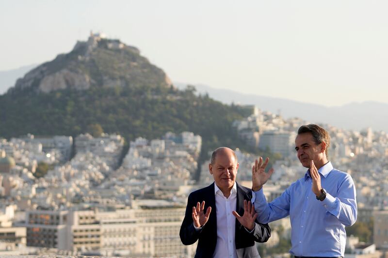 German Chancellor Olaf Scholz, left, and Greek Prime Minister Kyriakos Mitsotakis visit the landmarks of ancient Athens. AP