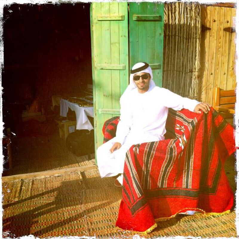 Day trip with friends to the Western Region and the Mazayin Dhafra Camel Festival, 220 kms west of Abu Dhabi on December 20, 2013.  A merchant poses outside his shop at the traditional souk.  Picture taken with the Hipstamatic app for the iPhone. Liz Claus / The National
