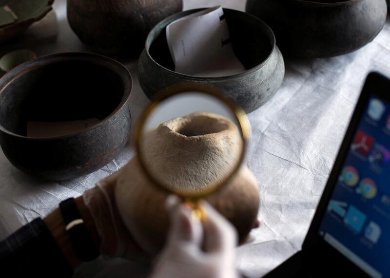 RAS AL KHAIMAH, UNITED ARAB EMIRATES - JULY 21 2019.

Ismail Sabry Draz, Head of Collection Unit at Ras Al Khaimah National Museum, carries out a visual documentation of found artifacts. He inspects an engraved pottery, dating to the 18th century, and found in Jalfar.

Around 20,000 archaeological artifacts have been documented by RAK antiquities and museums department as part of a three-year plan to document 100,000 artefacts. 

(Photo by Reem Mohammed/The National)

Reporter: 
Section: AC