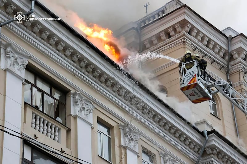 Rescuers tackle a blaze at a building struck by Russian bombs, in Dnipro. AP