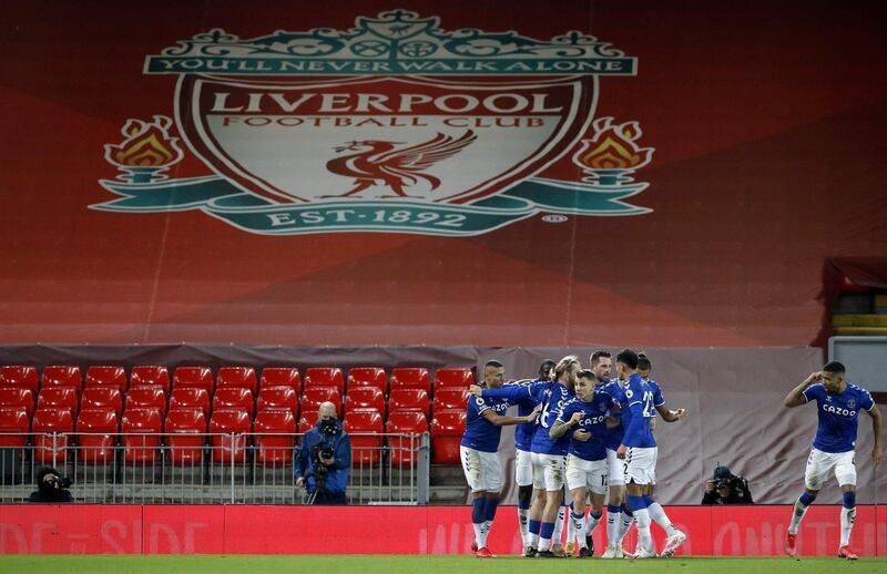 Everton players celebrate a goal at Anfield. EPA