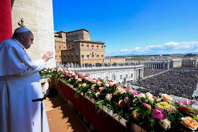 Pope Francis waves to the crowd in St Peter's square after delivering the Urbi et Orbi message and blessing for Easter. Vatican Media  /  AFP