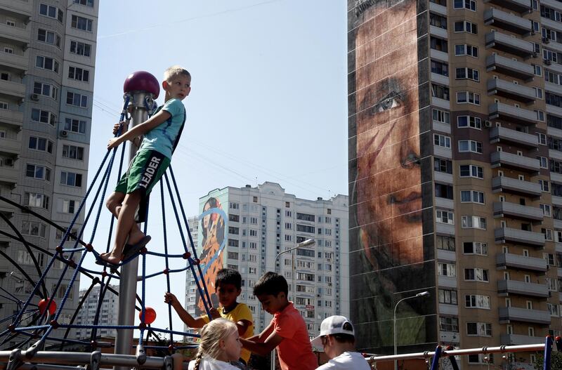 A graffiti depicting Yuri Gagarin (right), the first man in space, created by Italian artist Jorit Agoch at Trehgorka district in Odintsovo, near Moscow, Russia.  EPA