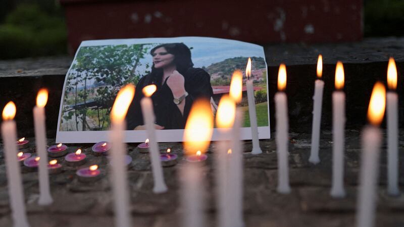 A photo of Mahsa Amini is placed among candles at a condolence meeting organised by students from Delhi University. Reuters