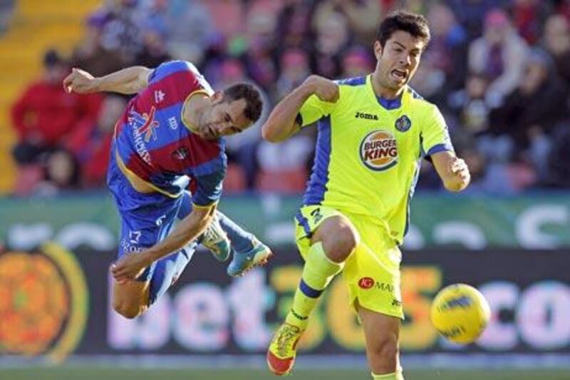 Levante's Juanfran Garcia, left, vies for the ball with Getafe's Venezuelan forward Nicolas Fedor 'Miku' .