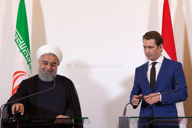 Austria's Chancellor Sebastian Kurz and Iranian President Hassan Rouhani (L) give a joint press conference following a meeting on July 4, 2018 at the Chancellery in Vienna.  / AFP / ALEX HALADA
