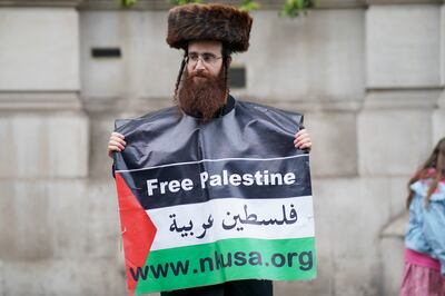 A participant in a pro-Palestine march on Whitehall in central London. 
PA