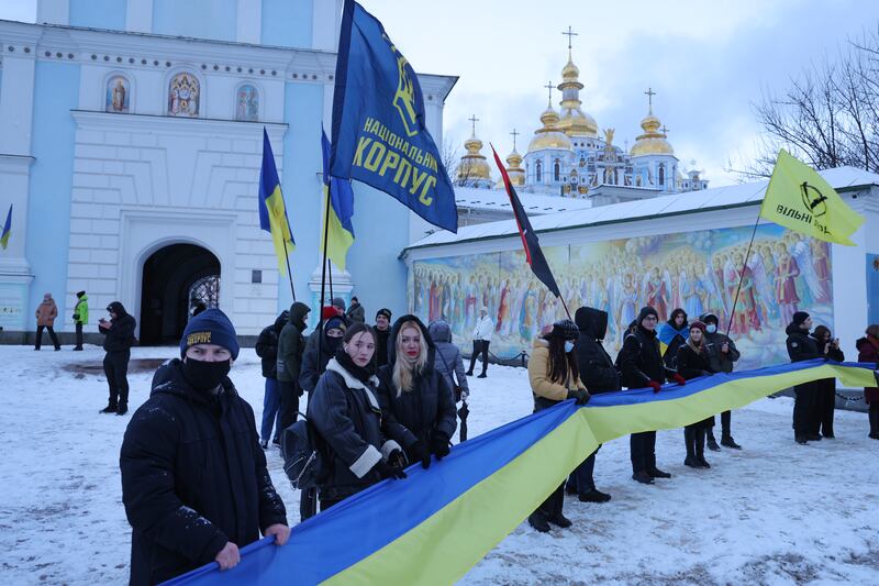 People rallying in patriotic support of Ukraine hold a 500-metre ribbon in the colours of the Ukrainian flag outside St Michael's Golden-Domed Monastery on Unity Day, in Kiev. Getty Images