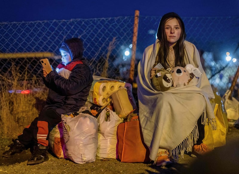 Helena, right, and her brother Bodia, from Lviv, wait at the Medyka border crossing in eastern Poland. AFP
