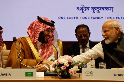 India's Prime Minister Narendra Modi (R) and Saudi Arabia's Crown Prince and Prime Minister Mohammed bin Salman speak during a session as part of the G20 Leaders' Summit at the Bharat Mandapam in New Delhi on September 9, 2023.  (Photo by Ludovic MARIN  /  POOL  /  AFP)