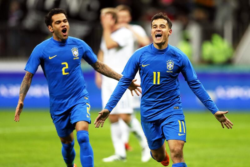 epa06624382 Philippe Coutinho (R) of Brazil celebrates with his teammate Dani Alves (L) after scoring the 2-0 lead from the penalty spot during the International Friendly soccer match between Russia and Brazil at Luzhniki stadium in Moscow, Russia, 23 March 2018.  EPA/YURI KOCHETKOV