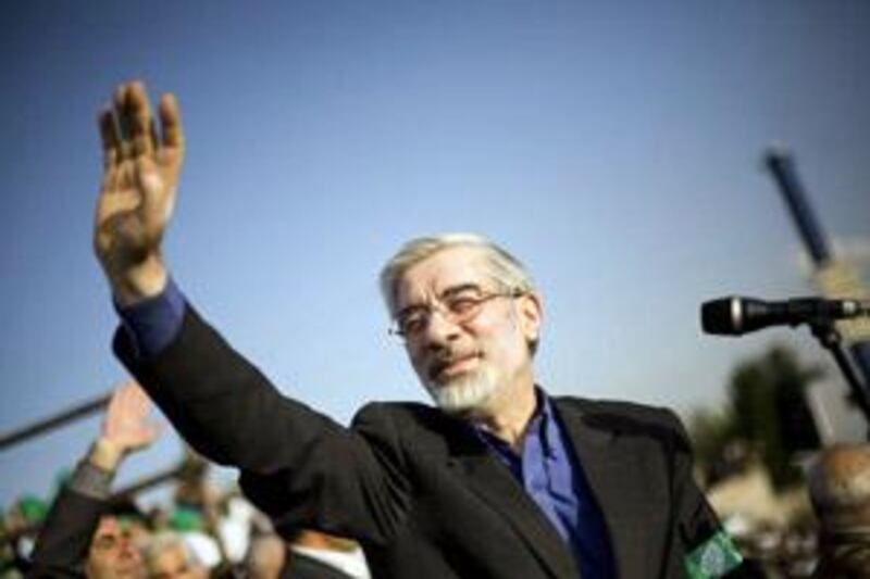 Mir Hosseing Mousave, the former Iran prime minister and a leading candidate in Friday's presidential elections, waves to supporters during a rally in Tehran this week.