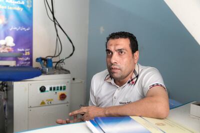 RAS AL KHAIMAH, UNITED ARAB EMIRATES - AUGUST 8, 2018. 

Ashraf Saqr, Egypt, works at Al Reesha Al Baydaa Laundry. Sewage lines extend above the ground and outside his shop in Al Mairid.

RAK sewage connection project is still under process. The project aims to connect about 565 residences and businesses in Al Mairid area to the sewerage network and removing the septic tanks. 

(Photo by Reem Mohammed/The National)

Reporter: RUBA HAZA
Section:  NA