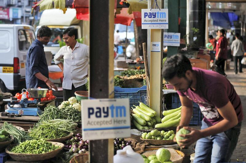 Advertisement boards of Paytm, a digital wallet company, are seen placed at stalls of roadside vegetable vendors as they wait for customers in Mumbai, India, November 19, 2016. Picture taken November 19, 2016. REUTERS/Shailesh Andrade - RC125A6CB600