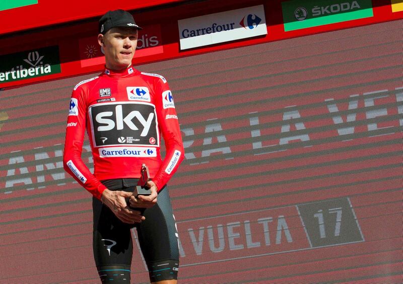 (FILES) This file photo taken on August 21, 2017 shows Sky's British cyclist Chris Froome posing on the podium with the leader's red jersey at the end of the 3rd stage of the 72nd edition of "La Vuelta" Tour of Spain cycling race in Andorra la Vella.
Froome, four-time winner of the Tour de France, has been tested positive for the bronchodilator 'Salbutamol' during the 2017 Tour of Spain that he won, the International Cycling Union (UCI) said in a statement on December 13, 2017. / AFP PHOTO / JAIME REINA